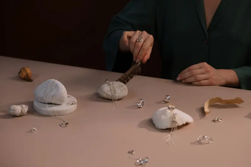 Elegant jewelry arrangement with rocks and natural textures on a table