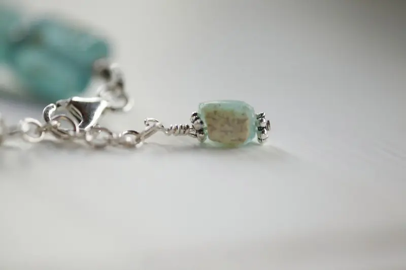 Close-up of a turquoise gemstone bracelet with silver detail, perfect for fashion and jewelry enthusiasts