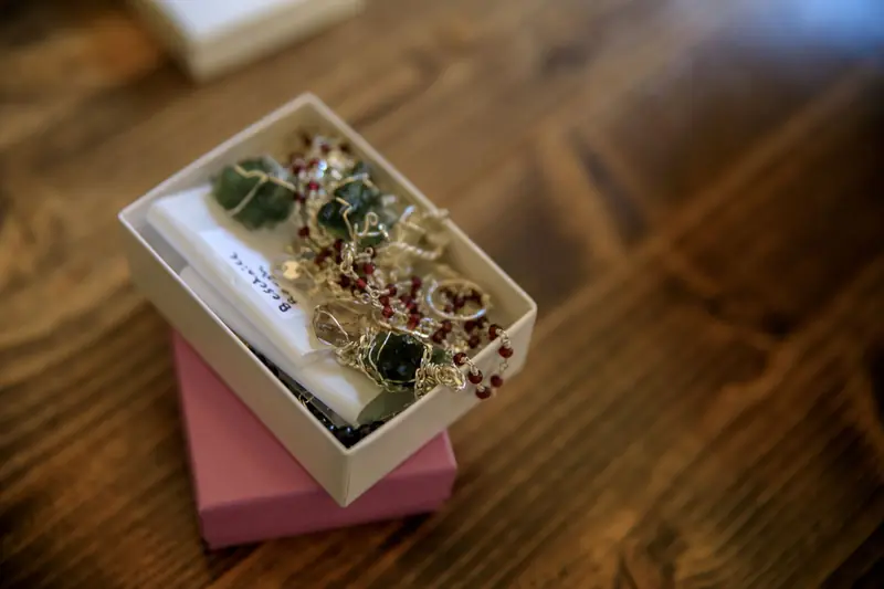 Close-up of handmade gemstone jewelry in a gift box, showcasing intricate craftsmanship and design